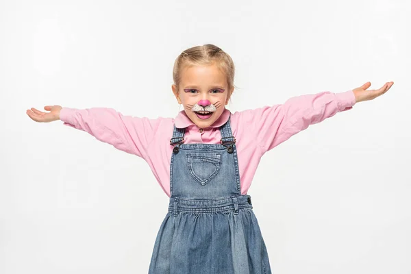 Positive child with cat muzzle painting on face standing with open arms while looking at camera isolated on white — Stock Photo