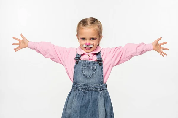 Cute child with cat muzzle painting on face standing with open arms while looking at camera isolated on white — Stock Photo