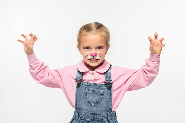 Cute child with cat muzzle painting on face showing frightening gesture while looking at camera isolated on white — Stock Photo