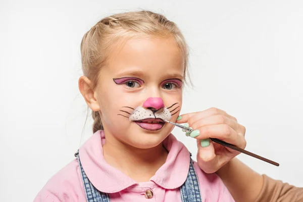 Cropped view of artist painting cat muzzle on face of adorable kid isolated on white — Stock Photo