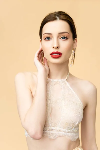 Attractive young woman looking at camera isolated on beige — Stock Photo