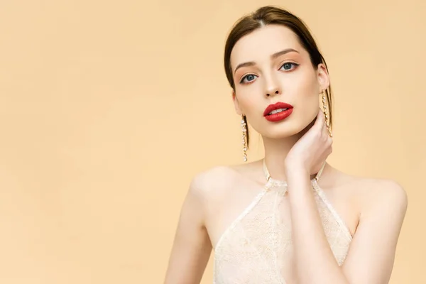 Young attractive woman looking at camera isolated on beige — Stock Photo