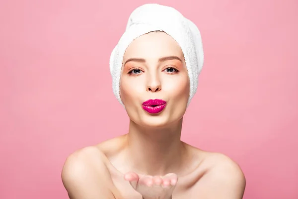 Happy naked woman in white towel sending air kiss isolated on pink — Stock Photo