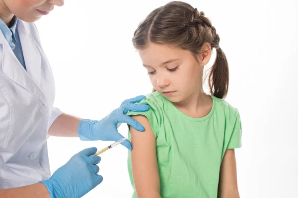 Female pediatrician doing vaccine injection to child isolated on white — Stock Photo