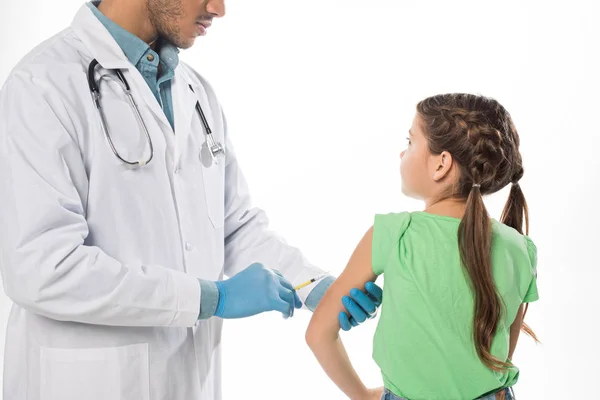 Pediatrician doing vaccine injection to kid isolated on white — Stock Photo