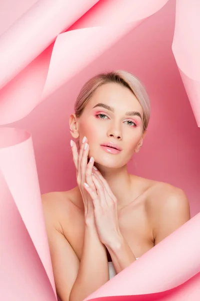 Hermosa chica tierna con maquillaje rosa en papel roto, en rosa - foto de stock