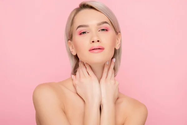 Sensuale ragazza nuda con trucco rosa guardando la fotocamera, isolato su rosa — Foto stock