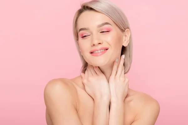 Cheerful naked woman with pink makeup, isolated on pink — Stock Photo