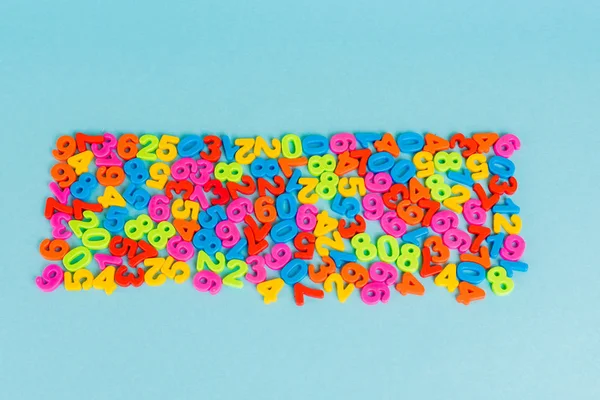 Top view of plastic colorful numbers on blue background — Stock Photo