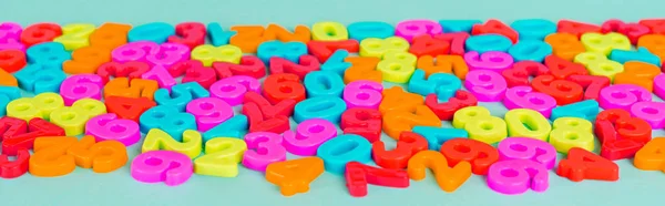 Colorful plastic numbers on blue background, panoramic shot — Stock Photo