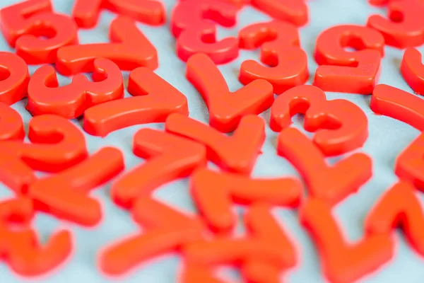 Selective focus of red plastic numbers on blue background — Stock Photo