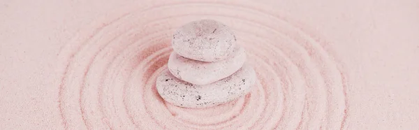 Panoramic shot of zen stones on pink sand with circles — Stock Photo