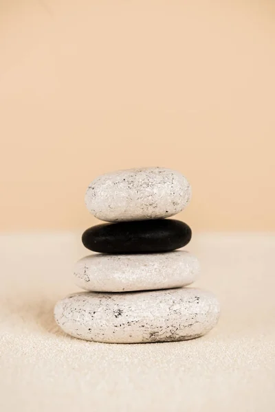 Close up view of natural zen stones on sand on beige background — Stock Photo