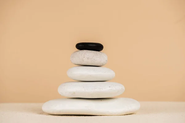 Zen stones on sand surface isolated on beige — Stock Photo