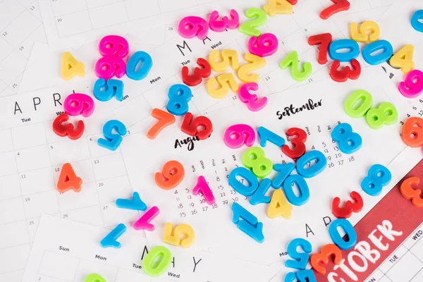 High angle view of plastic numbers on monthly calendars — Stock Photo