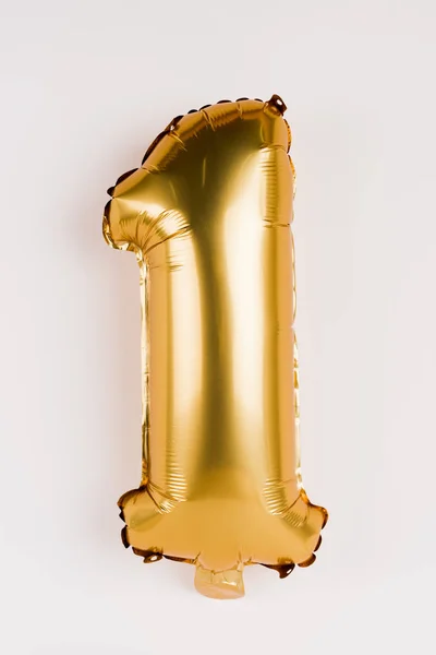 Festive golden balloon in shape of one number on grey background — Stock Photo