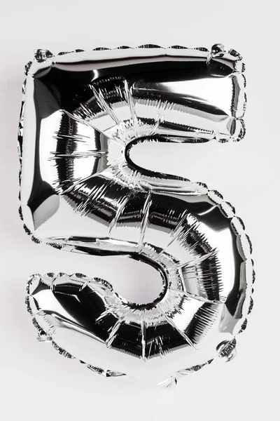 Silver balloon in shape of five number on grey background — Stock Photo