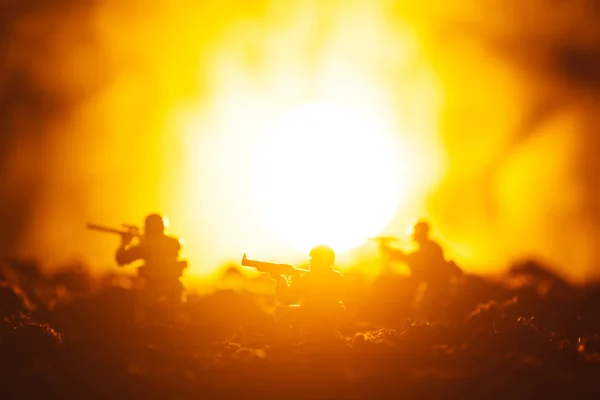 Battle scene with toy warriors in smoke and sunset at background — Stock Photo