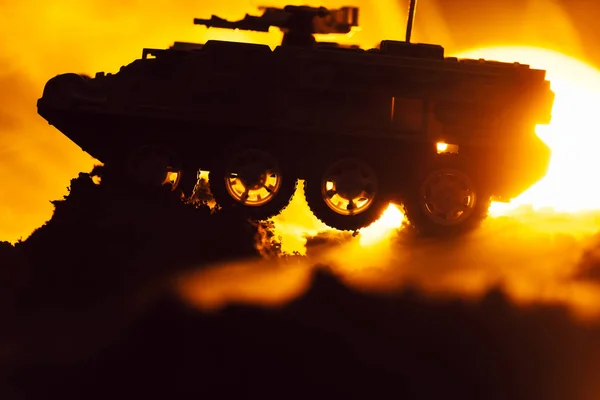 Battle scene with toy tank in fire and sunset at background — Stock Photo