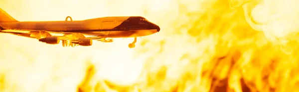 Battle scene with toy plane with fire at background, panoramic shot — Stock Photo