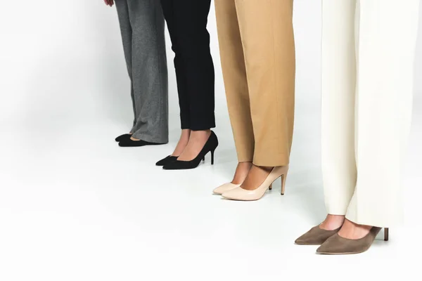 Cropped view of multicultural businesswoman standing on white — Stock Photo