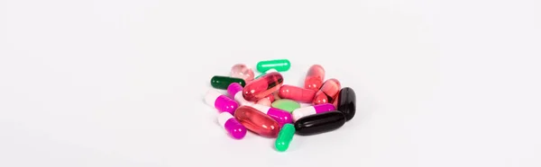 Panoramic shot of colorful pills isolated on white — Stock Photo