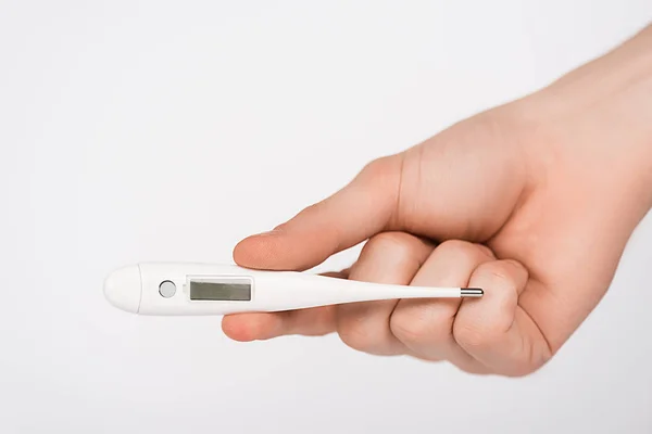 Cropped view of woman holding digital thermometer isolated on white — Stock Photo