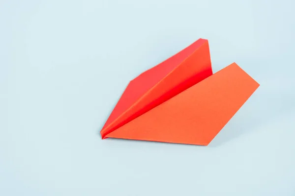 Toy and orange paper plane on blue with copy space — Stock Photo