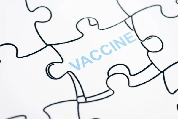 Close up of puzzle pieces with vaccine lettering — Stock Photo