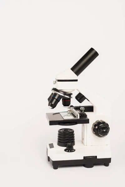 Microscópio moderno isolado em branco com espaço de cópia — Fotografia de Stock