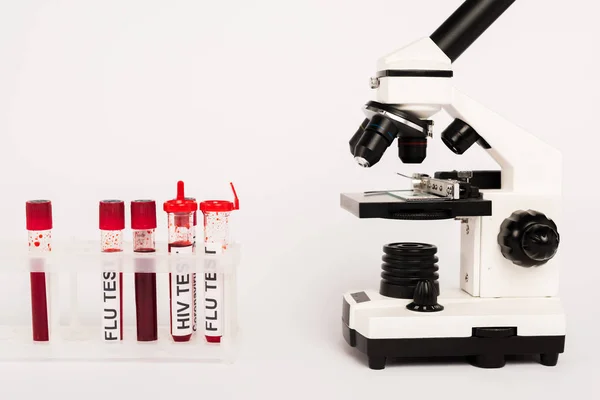 Микроскоп и образцы с надписью на белом — стоковое фото