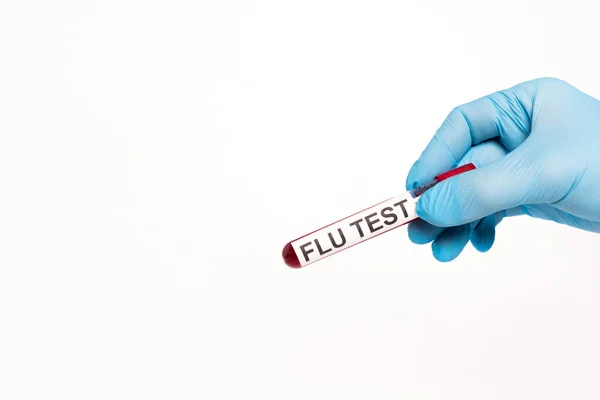 Cropped view of scientist holding test tube with flu test lettering isolated on white — Stock Photo