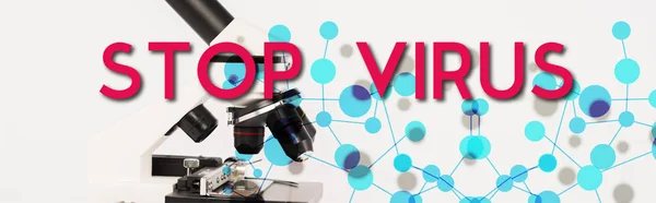 Panoramic shot of modern microscope near stop virus lettering on white — Stock Photo