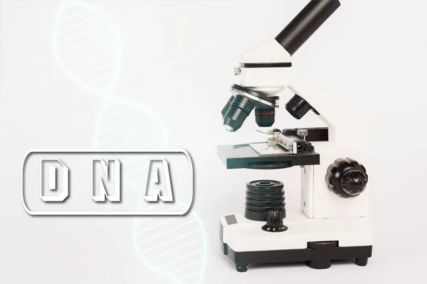 Microscope near dna lettering and illustration on white — Stock Photo