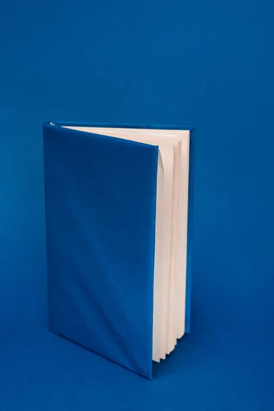 Bright book with copy space on blue background — Stock Photo