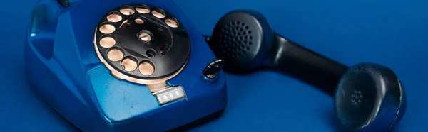 Panoramic shot of retro telephone on blue background — Stock Photo