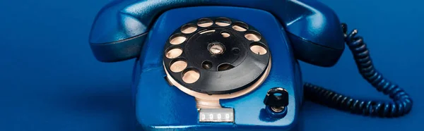 Panoramic shot of retro telephone on blue background — Stock Photo