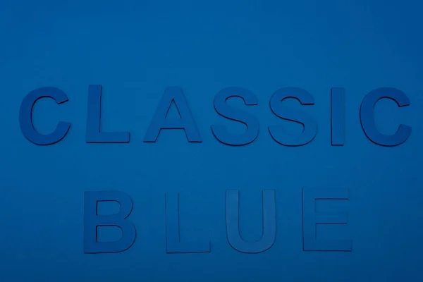 Top view of classic blue lettering isolated on blue — Stock Photo