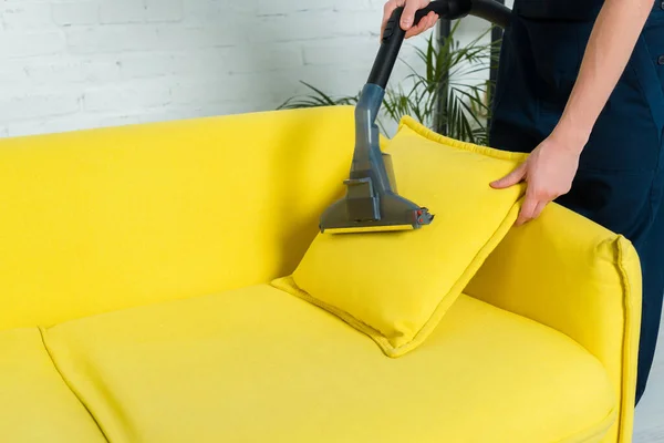 Cropped view of man removing dust on pillow with vacuum cleaner — Stock Photo