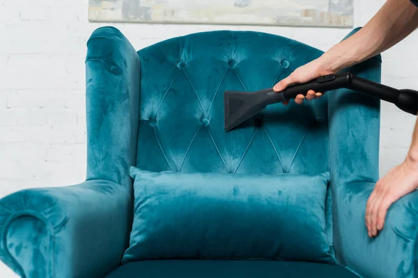 Cropped view of cleaner washing modern armchair with vacuum cleaner — Stock Photo