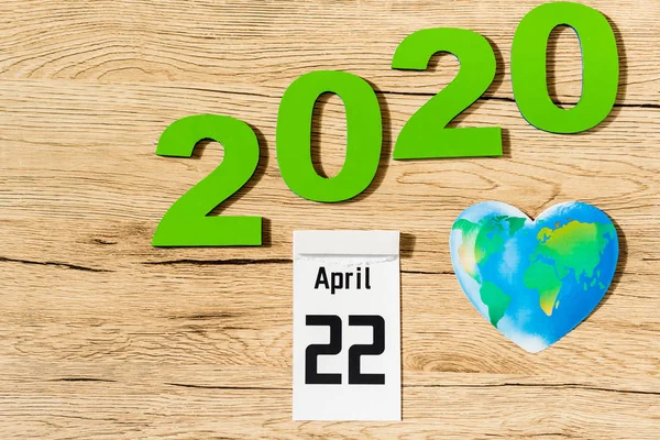 Top view of date 22 april 2020 and globe on wooden background, earth day concept — Stock Photo