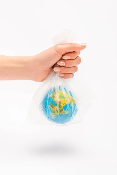 Partial view of woman holding plastic bag with globe on white background, global warming concept — Stock Photo