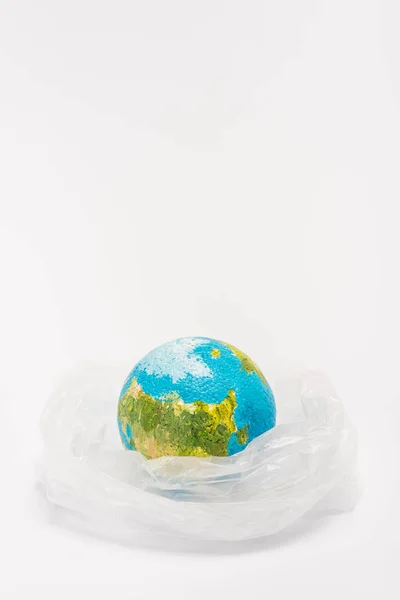 Globe intérieur sac en plastique sur fond blanc, concept de réchauffement climatique — Photo de stock