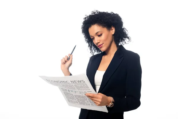 Concentrated african american businesswoman with pen and newspaper isolated on white — Stock Photo