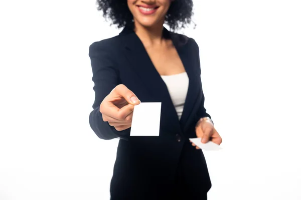 Vista recortada de la mujer de negocios afroamericana sonriendo y presentando tarjeta de visita aislada en blanco - foto de stock