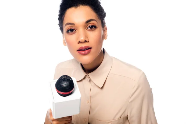Portrait of african american journalist with microphone looking at camera isolated on white — Stock Photo