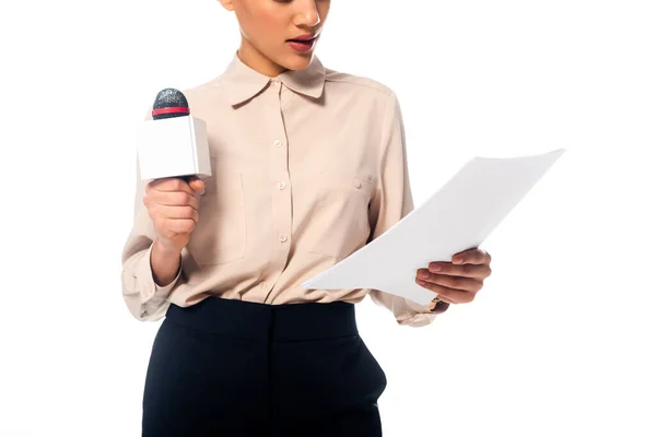 Cropped view of african american journalist with microphone reading documents isolated on white — Stock Photo