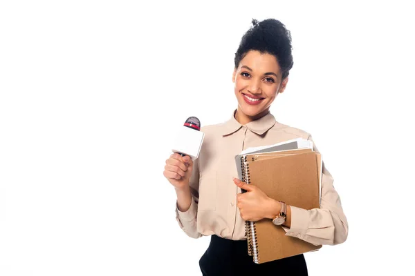 Jornalista afro-americano com microfone, documentos e cadernos olhando para câmera isolada em branco — Fotografia de Stock