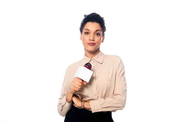 Front view of skeptical african american journalist with microphone looking at camera isolated on white — Stock Photo