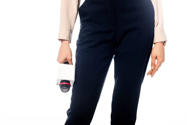 Vista ritagliata di giornalista afroamericano in pantaloni neri con microfono isolato su bianco — Foto stock